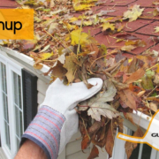 Gloved hand scooping leaves out of gutter, gutters r us logo, fall cleanup blog title